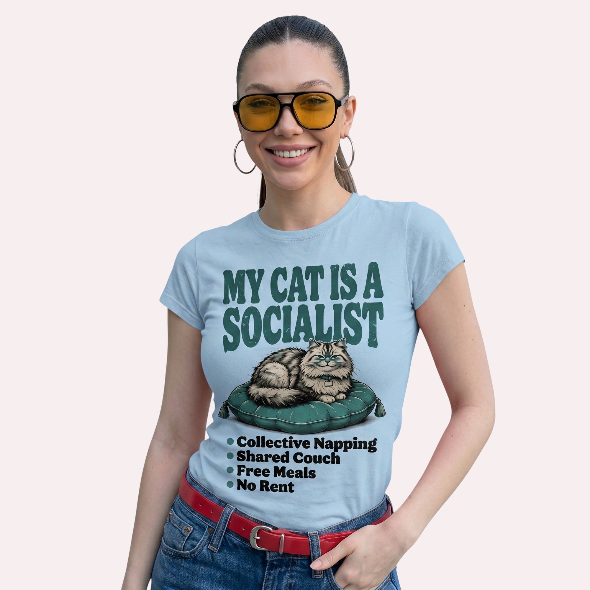 TrendyShift.Com light blue cotton graphic tee featuring a cat illustration and My Cat Is a Socialist text on a woman